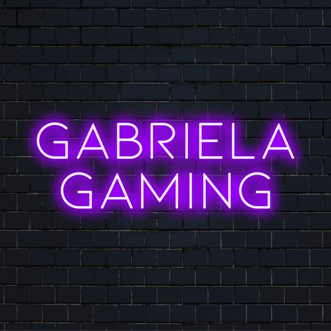 Gabriela Gaming Personalized Neon Light with bright LED glow against black brick wall