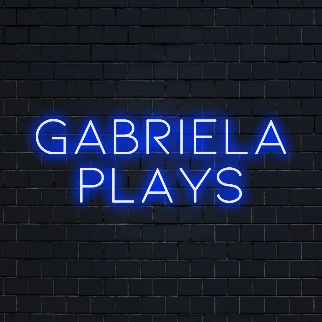 Gabriela Plays Personalized Neon Light with glowing neon text on dark brick wall