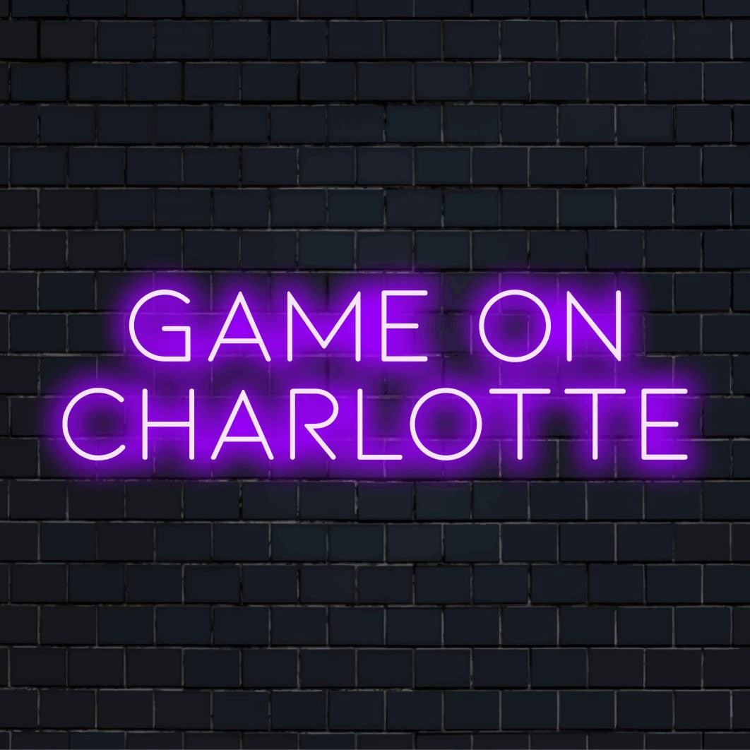 Game On Charlotte Personalized LED Neon Sign, glowing lettering against black brick wall