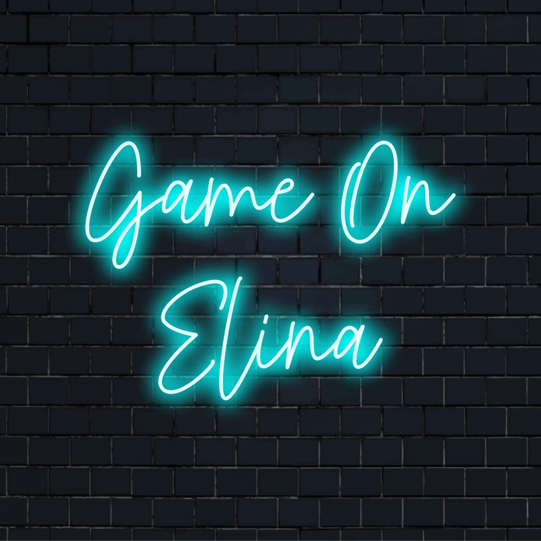 Game On Elina Personalized LED Neon Sign, glowing lettering against black brick wall