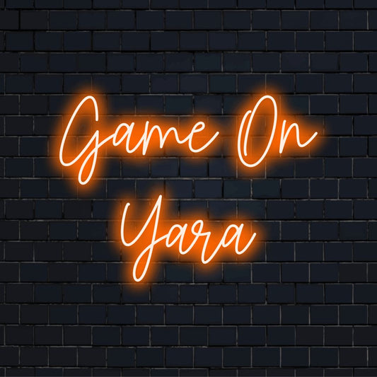 Game On Yara Personalized Neon Light with glowing lettering against black brick wall