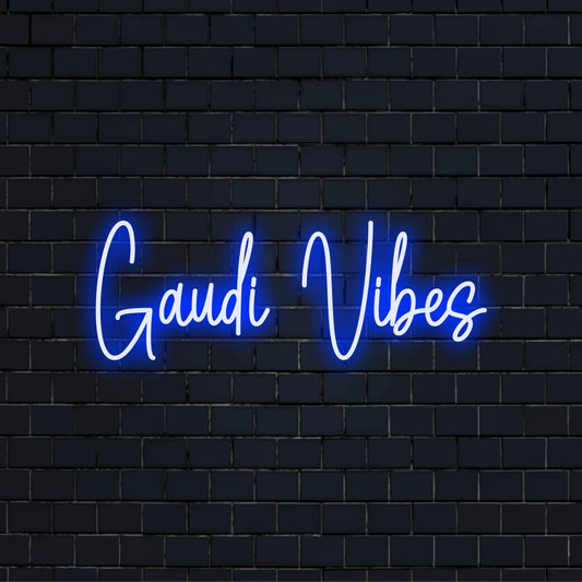 Gaudi Vibes Neon Light with neon text light against black brick wall