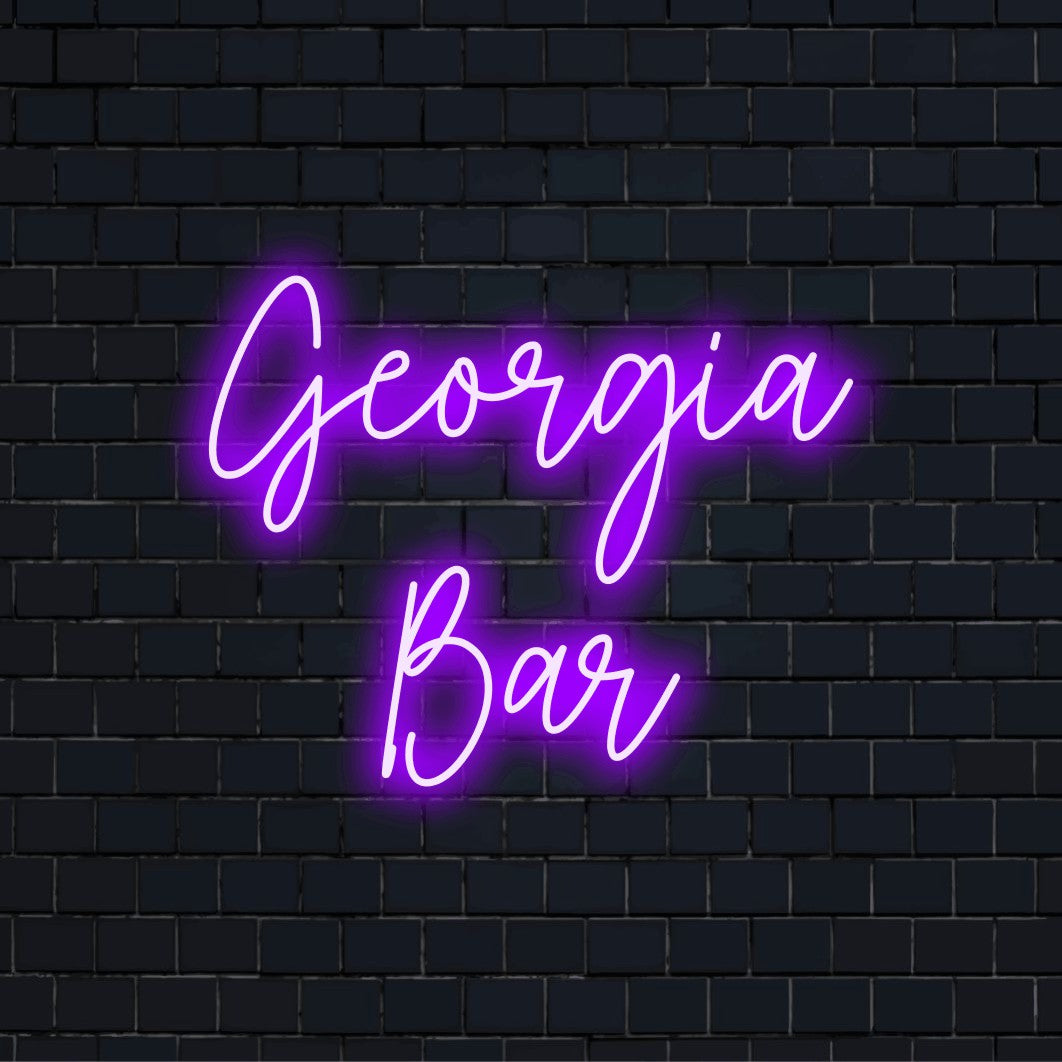 Georgia Bar Personalized Neon Light with glowing lettering against brick backdrop
