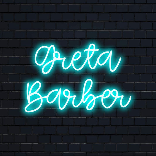 Greta Barber Personalized Neon Light with glowing lettering against brick backdrop
