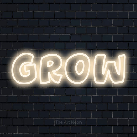 "Grow" script-style LED neon sign on a black brick wall