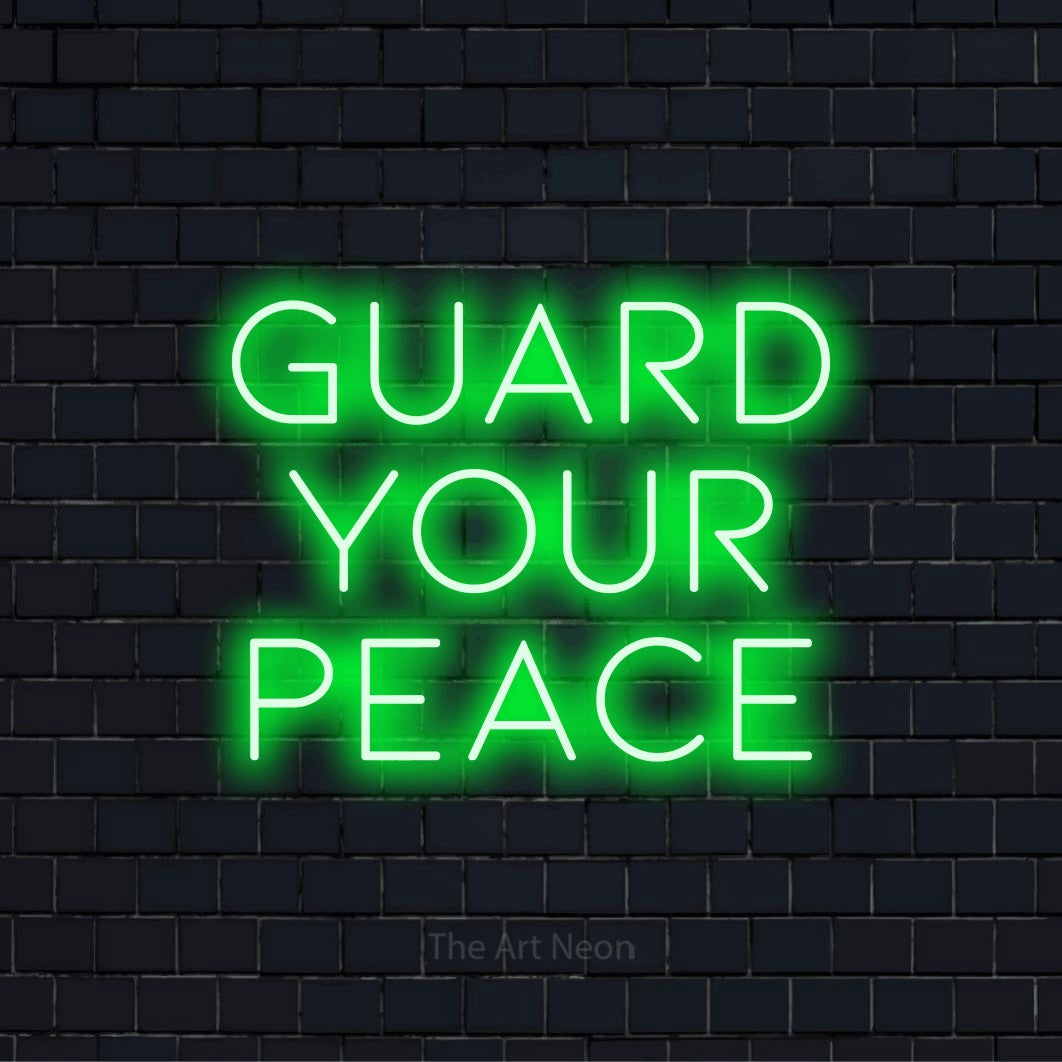 "Guard Your Peace" neon text design on a black brick wall