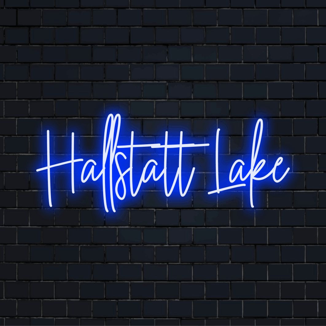 Hallstatt Lake LED Neon Sign, glowing lettering against black brick wall