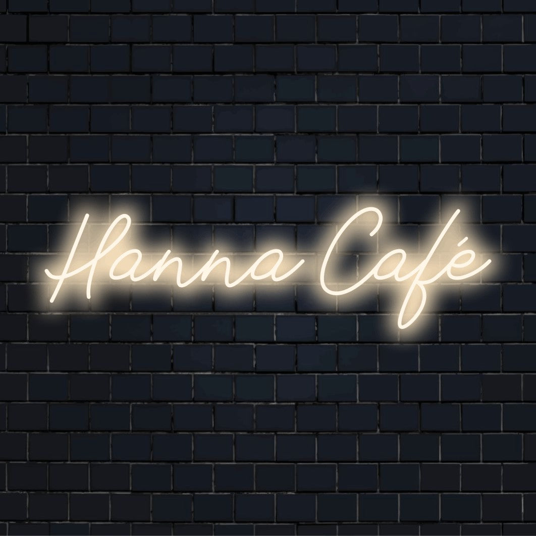 Hanna Cafe Personalized LED Neon Sign, bright neon glow on dark brick wall