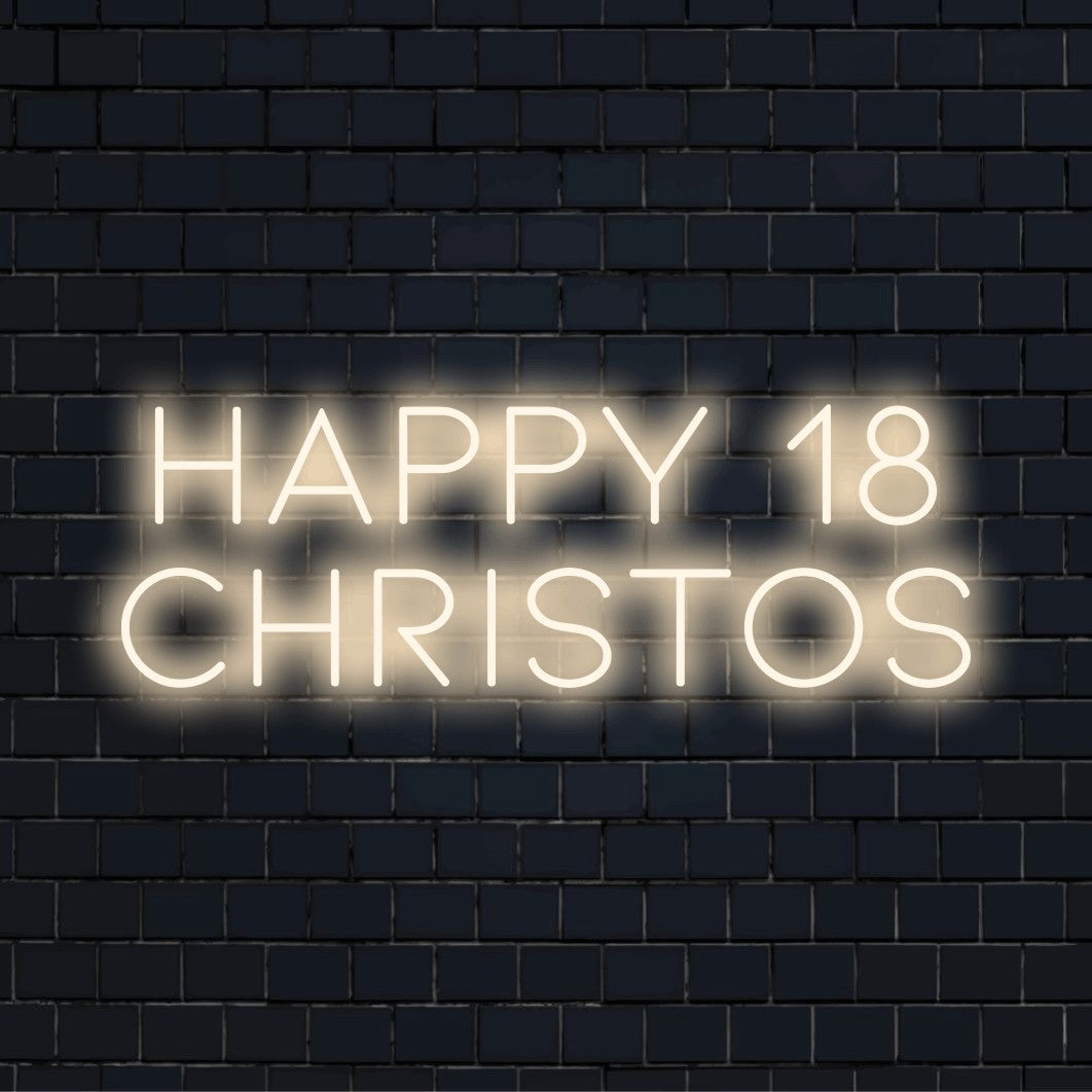 Happy 18 Christos Custom Name Neon Sign, glowing lettering against black brick wall