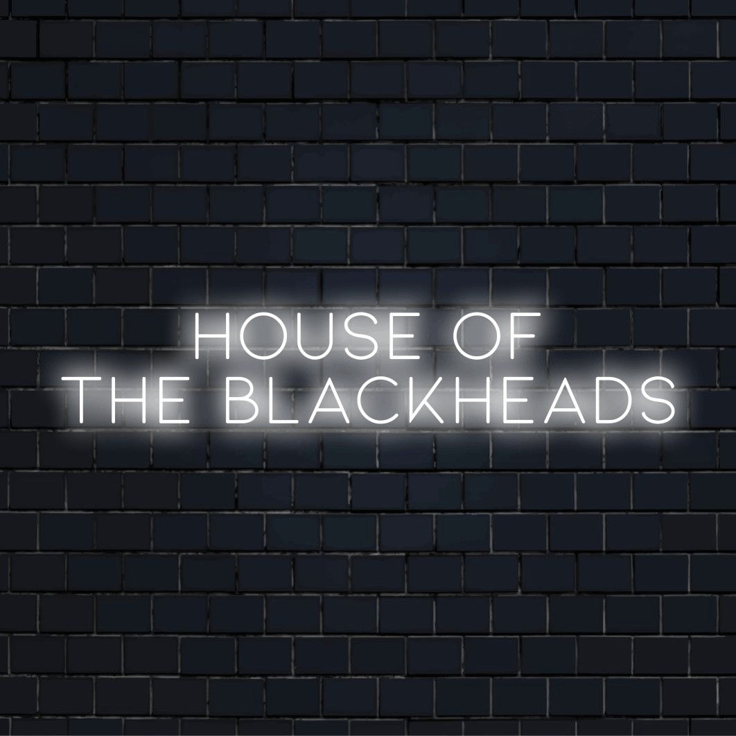 House Of The Blackheads LED Neon Sign, bright neon glow against black brick wall