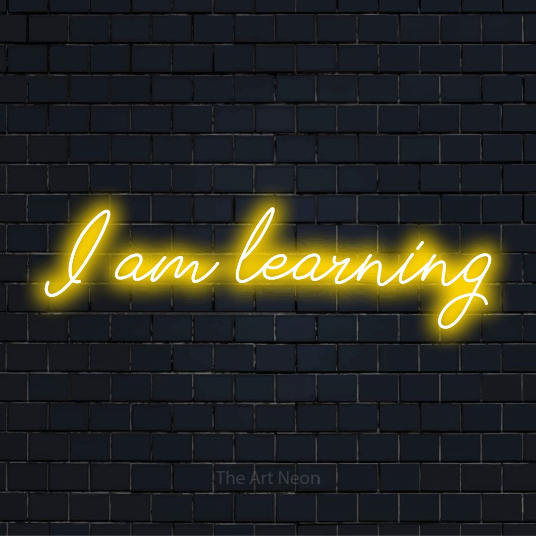 "I Am Learning" neon text design on a black brick wall