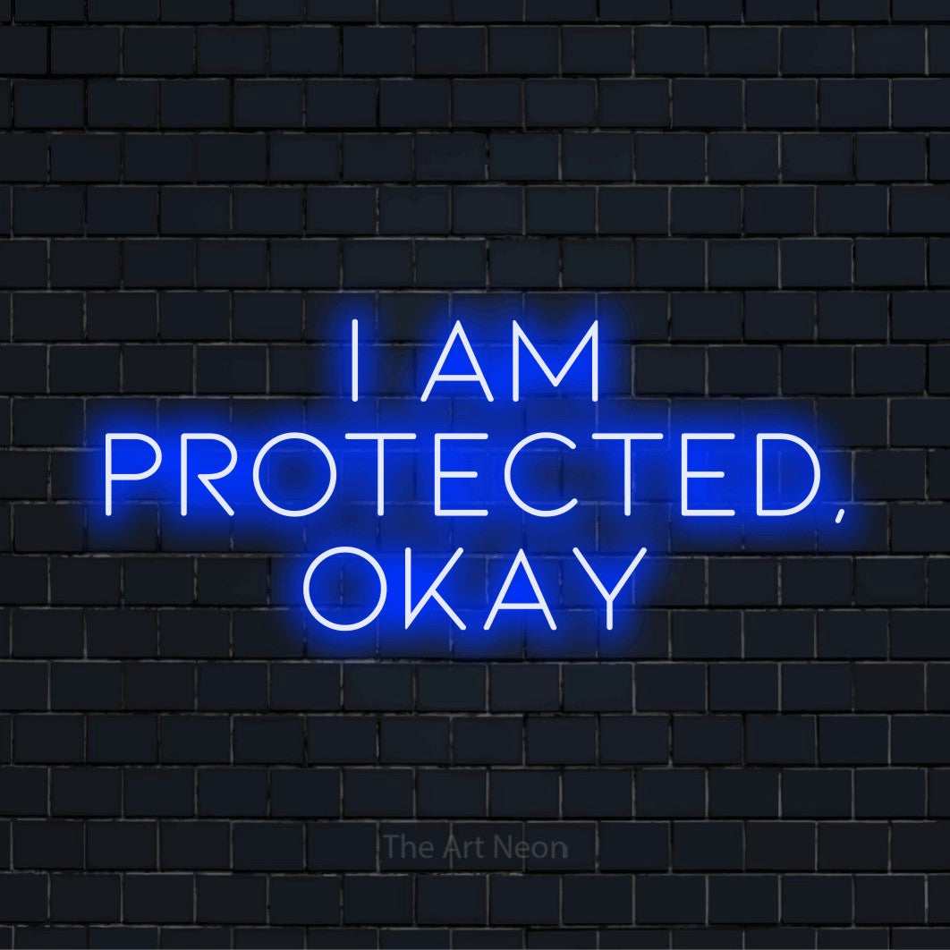 "I Am Protected, Okay" text design with neon effect on a black brick wall