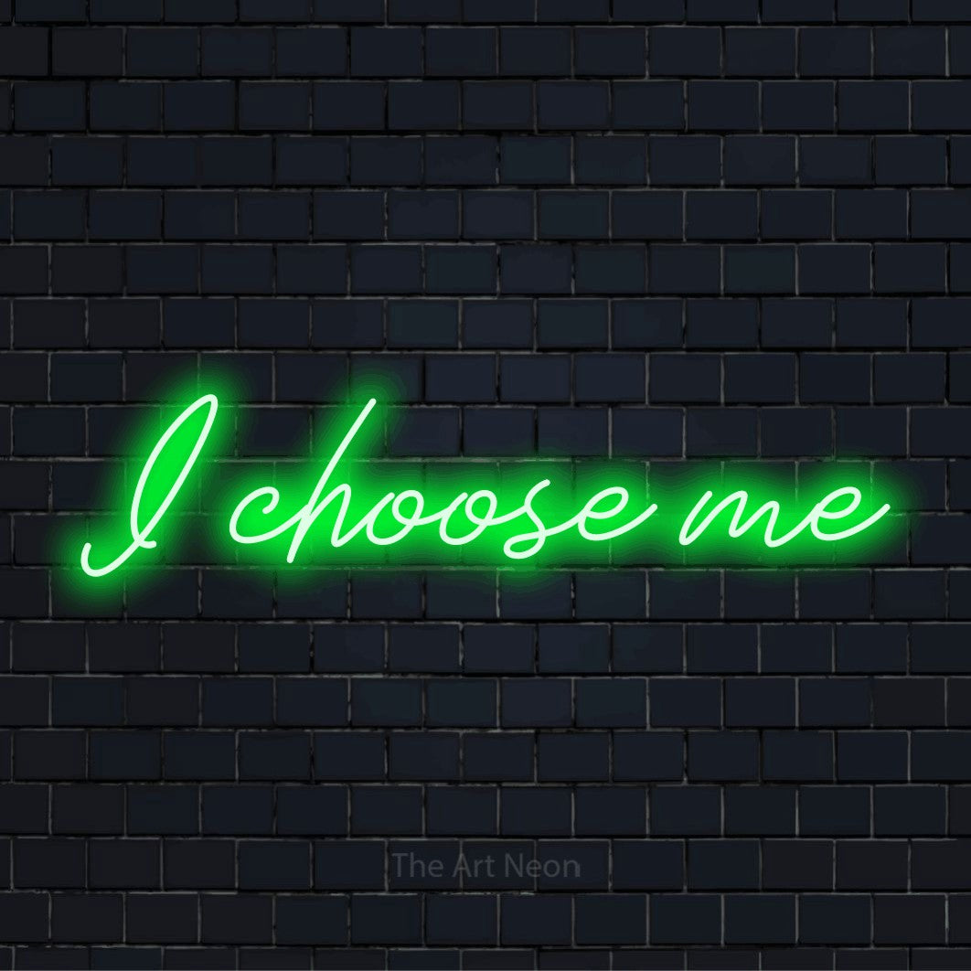 "I Choose Me" glowing LED neon sign on a black brick wall