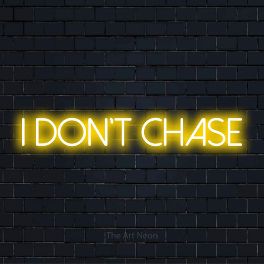 "I Don’t Chase" glowing LED neon sign on a black brick wall