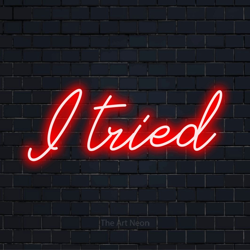 "I Tried" glowing LED neon sign on a black brick wall