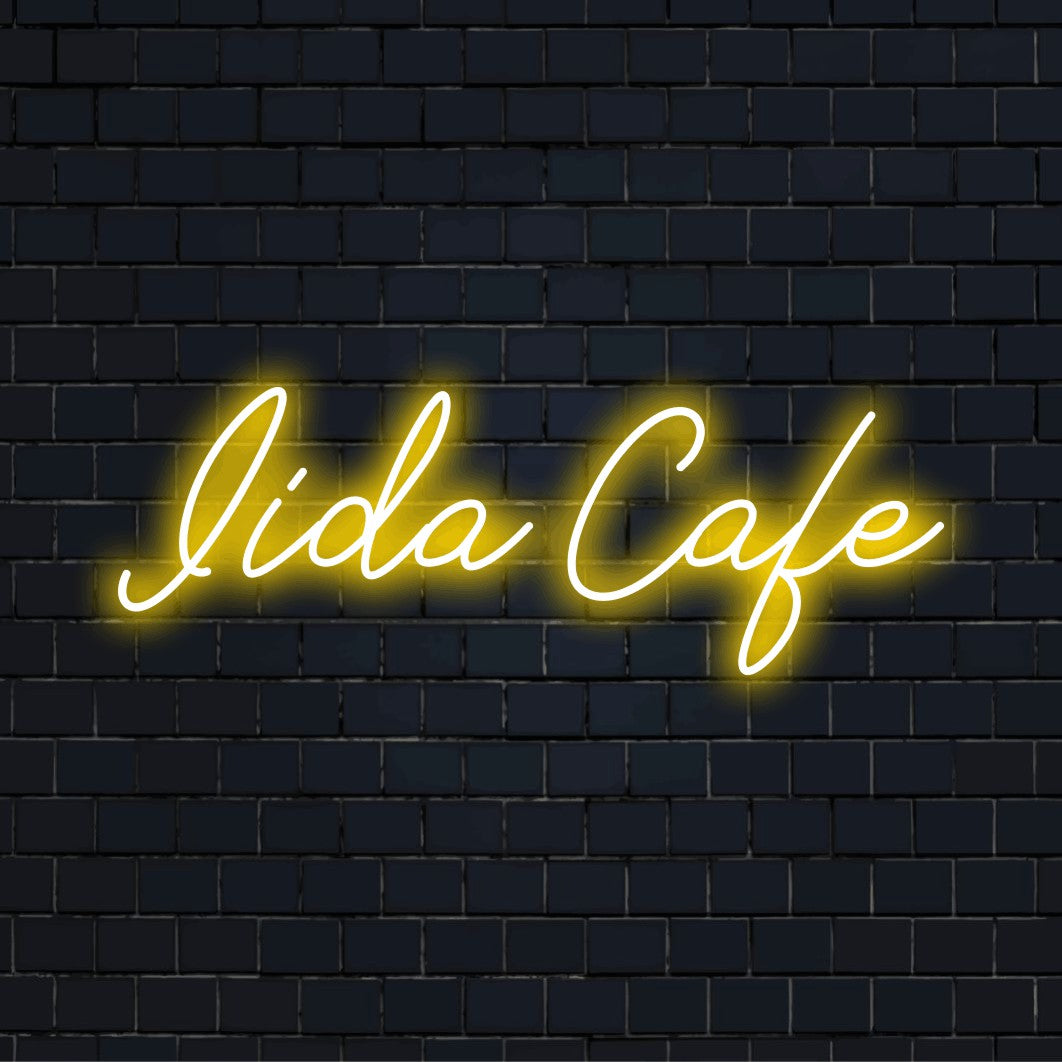 Iida Cafe Personalized LED Neon Sign, glowing wall decor against brick backdrop