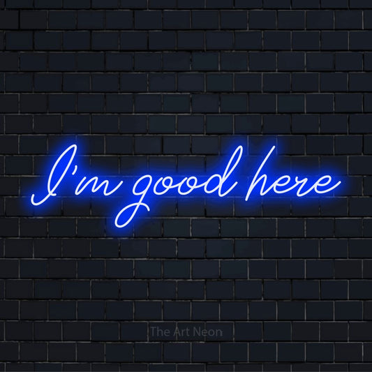 "I’m Good Here" glowing LED neon sign on a black brick wall