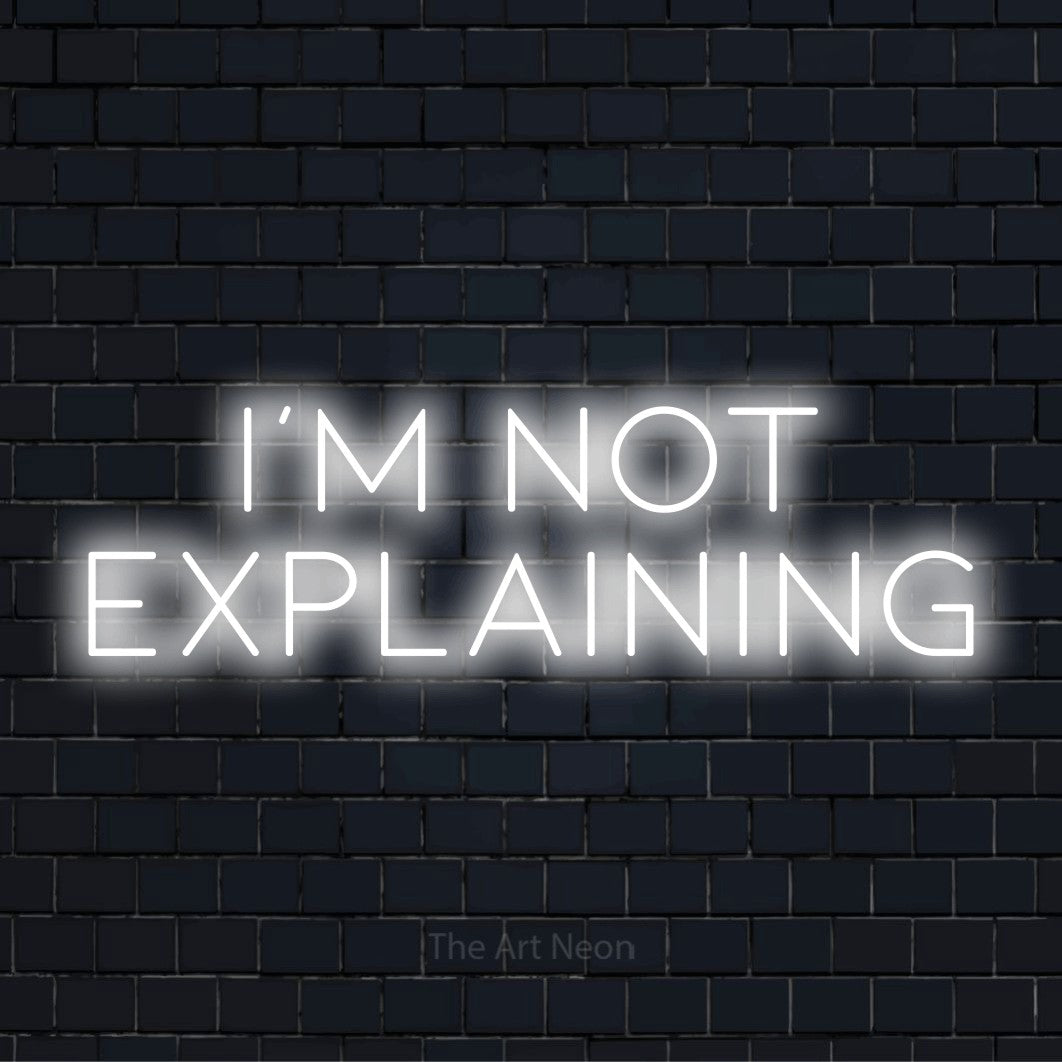 "I’m Not Explaining" neon text design on a black brick wall