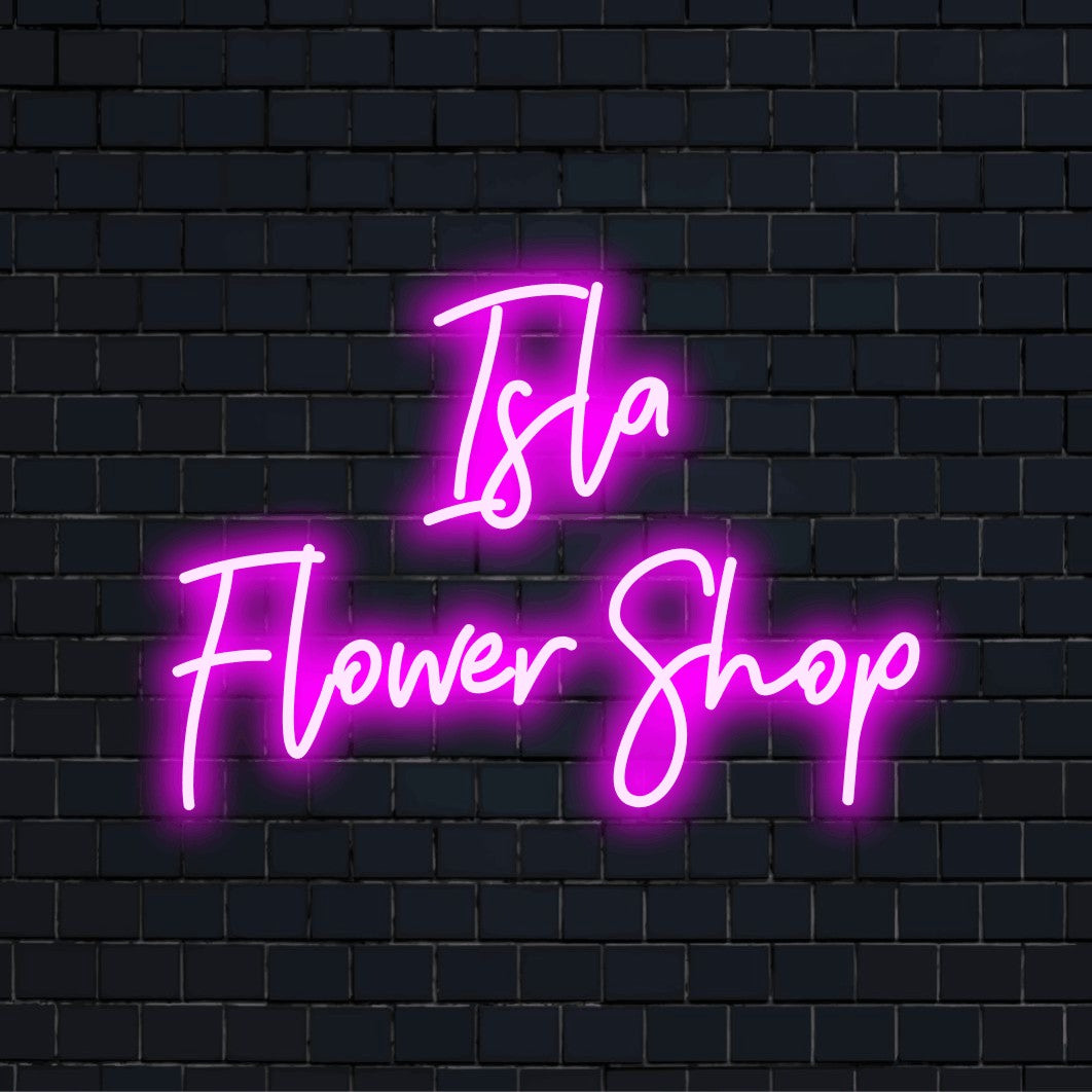Isla Flower Shop Custom Name Neon Sign, bright neon glow on dark brick wall