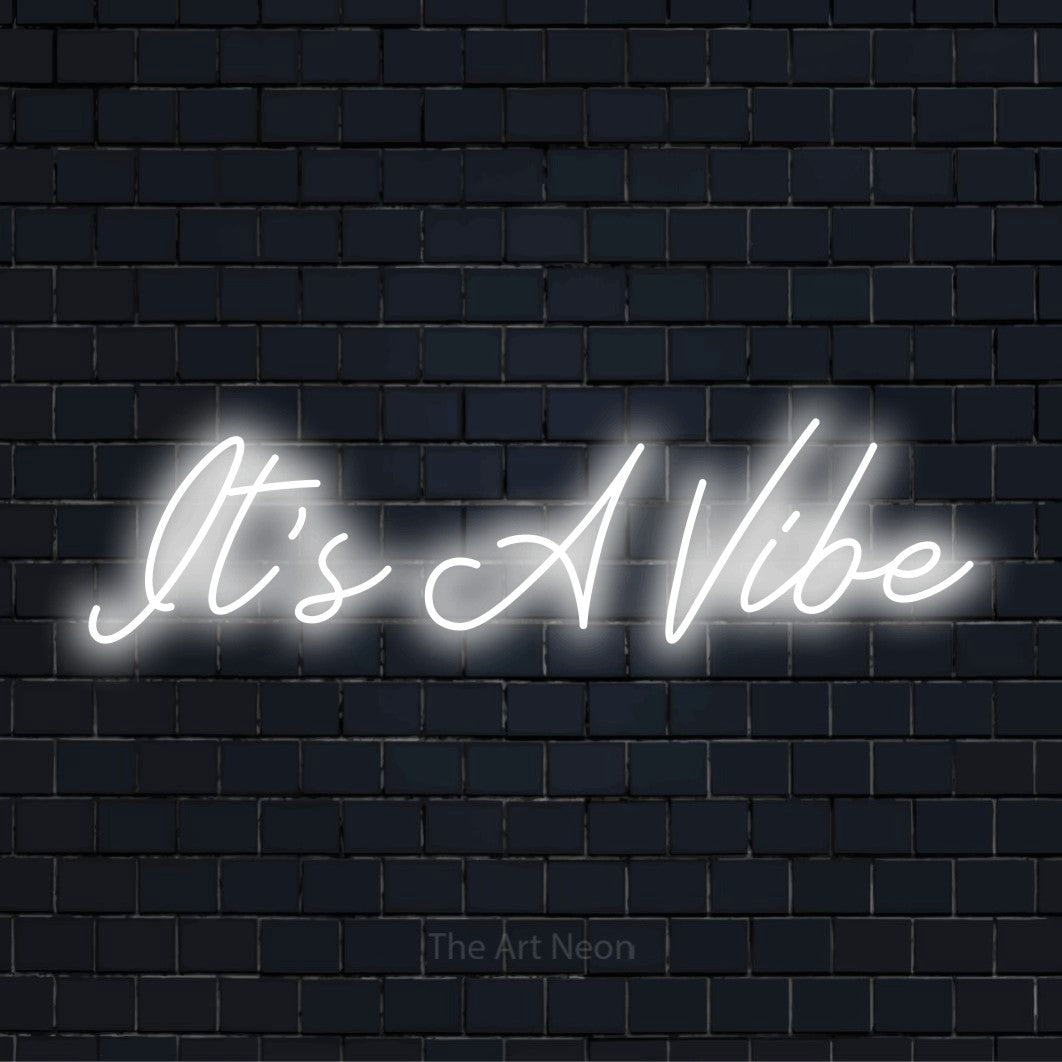 "It’s A Vibe" neon text design on a black brick wall