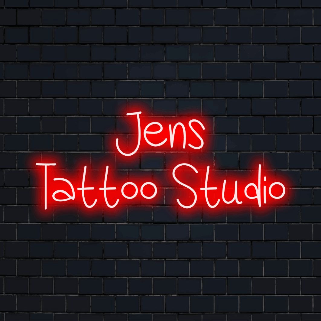 Jens Tattoo Studio Personalized LED Neon Sign, bright neon glow against black brick wall