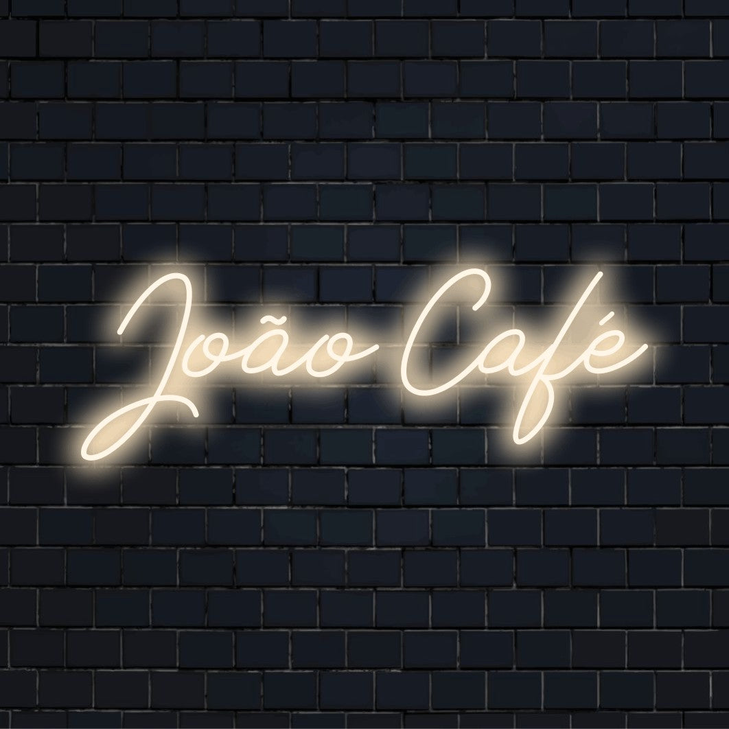Joao Cafe Personalized LED Neon Sign, bright neon glow against brick backdrop