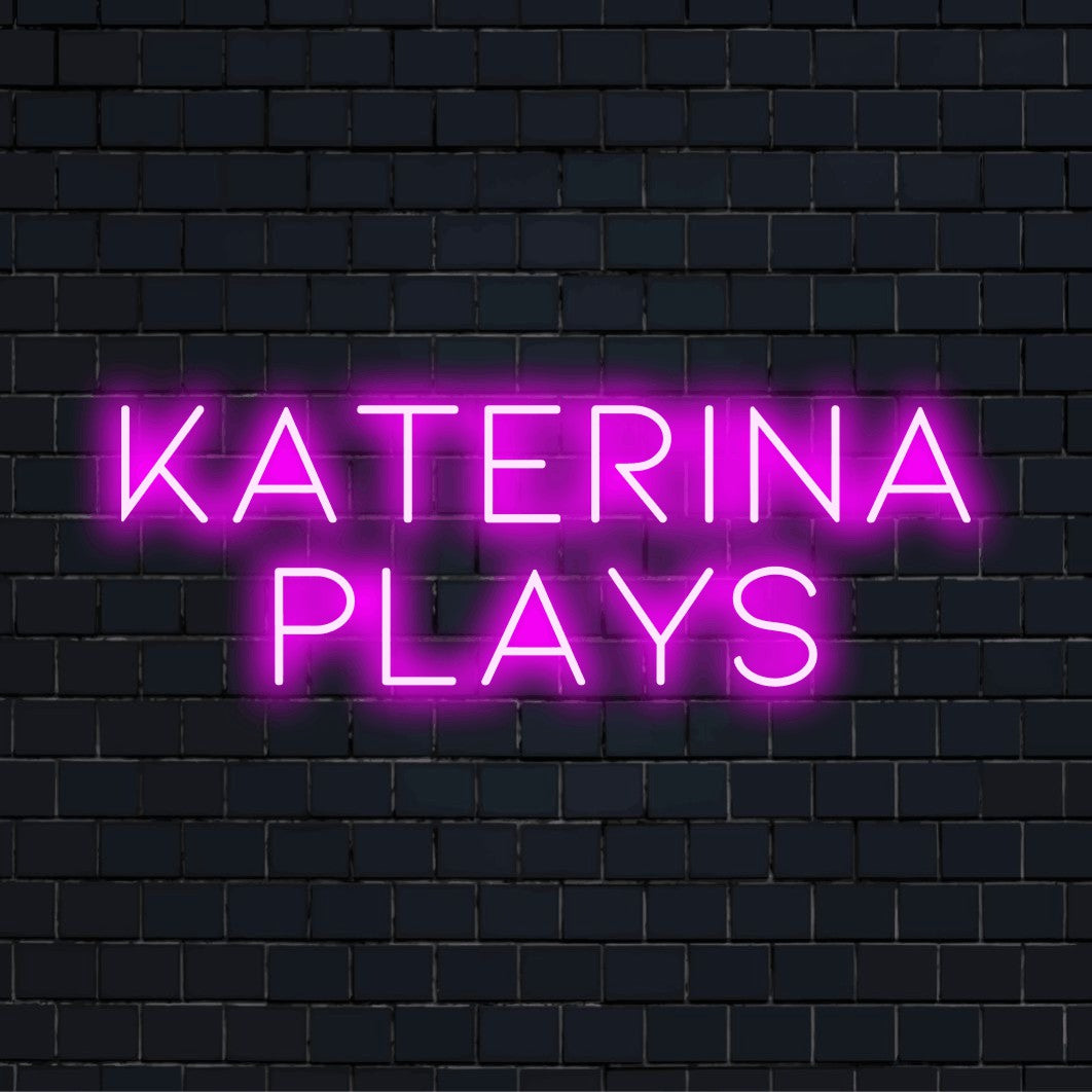 Katerina Plays Custom Name Neon Sign, glowing neon text against brick backdrop