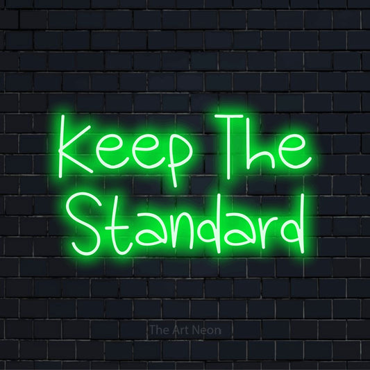 "Keep The Standard" LED neon sign on a black brick wall