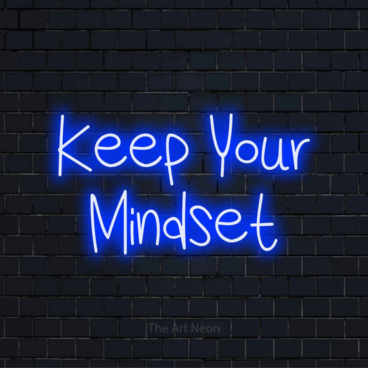 "Keep Your Mindset" text design with neon effect on a black brick wall