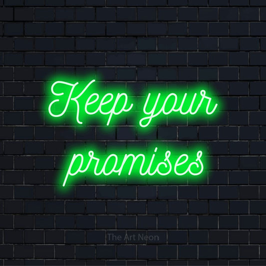 "Keep Your Promises" script-style LED neon sign on a black brick wall
