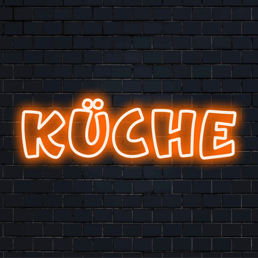 LED-Neonschild mit dem Text „Küche“ auf dunkler Ziegelwand