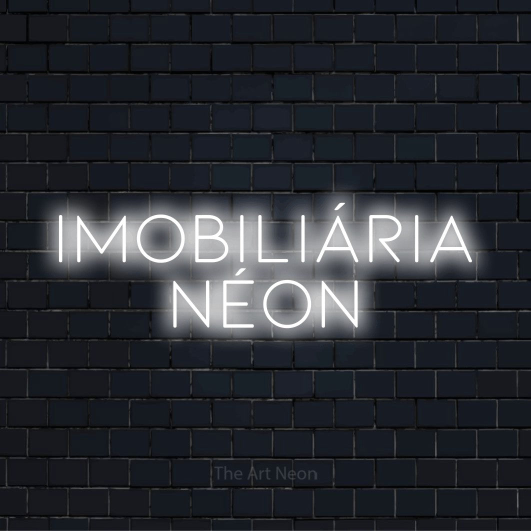 Letreiro néon LED com o design “Imobiliária Néon” numa parede escura