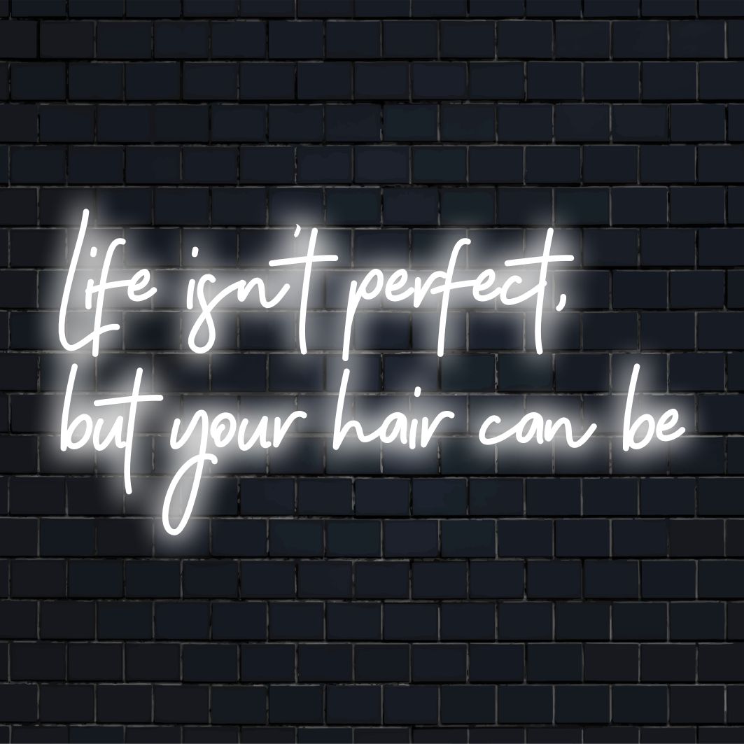 Custom-made LED neon sign featuring the phrase Life Isn't Perfect, But Your Hair Can Be in vibrant, stylish letters.