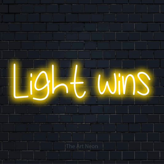 "Light Wins" text design with neon effect on a black brick wall
