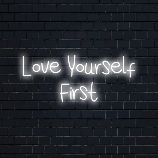 Love Yourself First LED Neon Sign, bright neon glow against black brick wall
