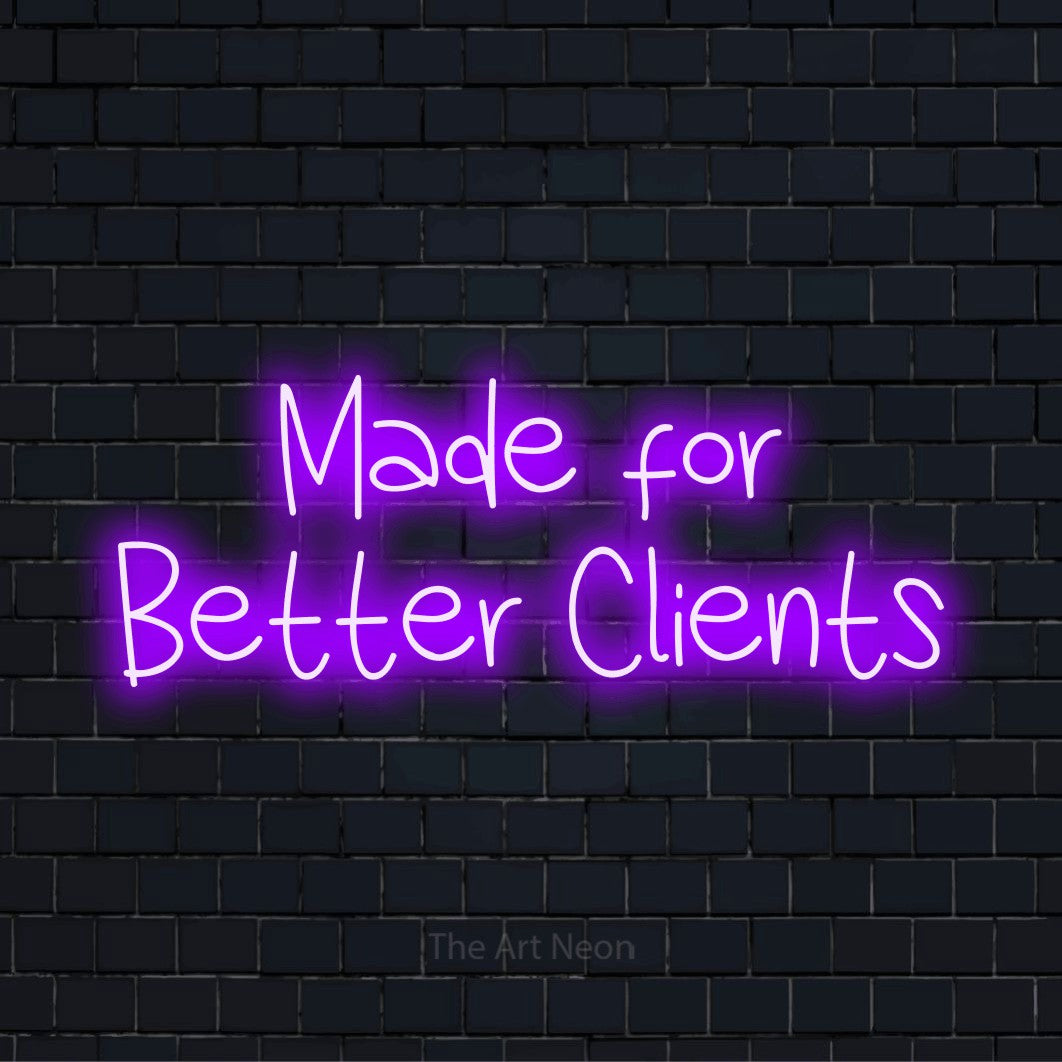 "Made For Better Clients" LED neon sign on a black brick wall