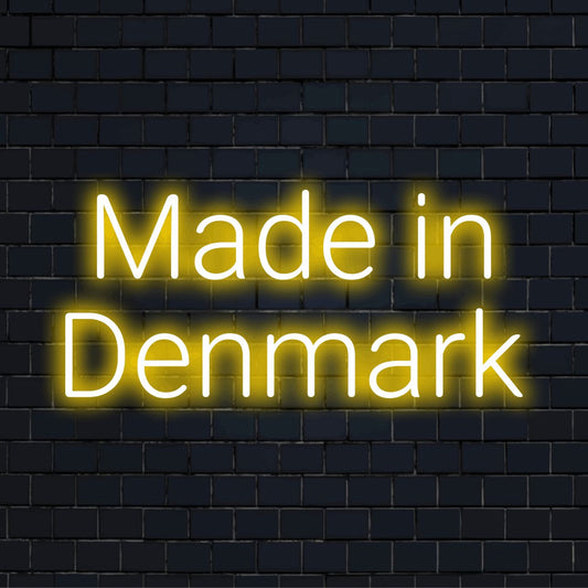Made In Denmark LED Neon Sign, glowing wall decor on dark brick background