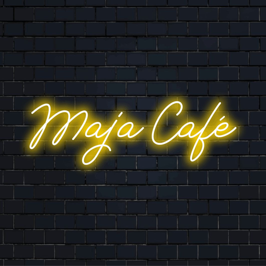 Maja Cafe Custom Name Neon Sign, bright LED glow on dark brick wall