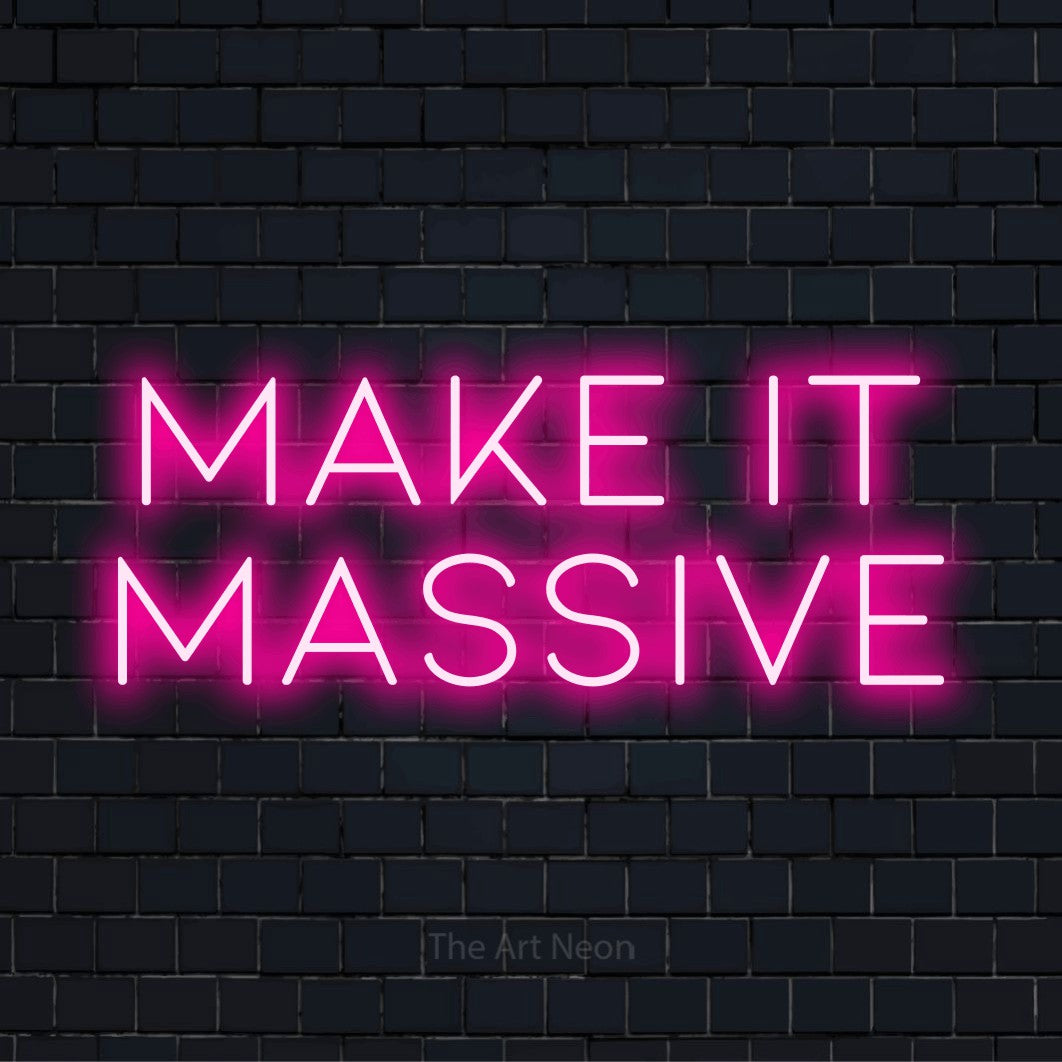 "Make It Massive" glowing LED neon sign on a black brick wall