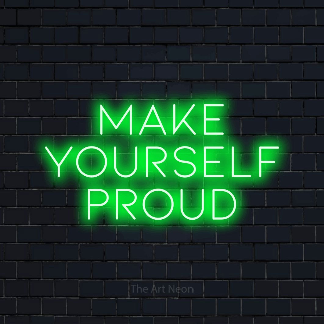 "Make Yourself Proud" neon text design on a black brick wall