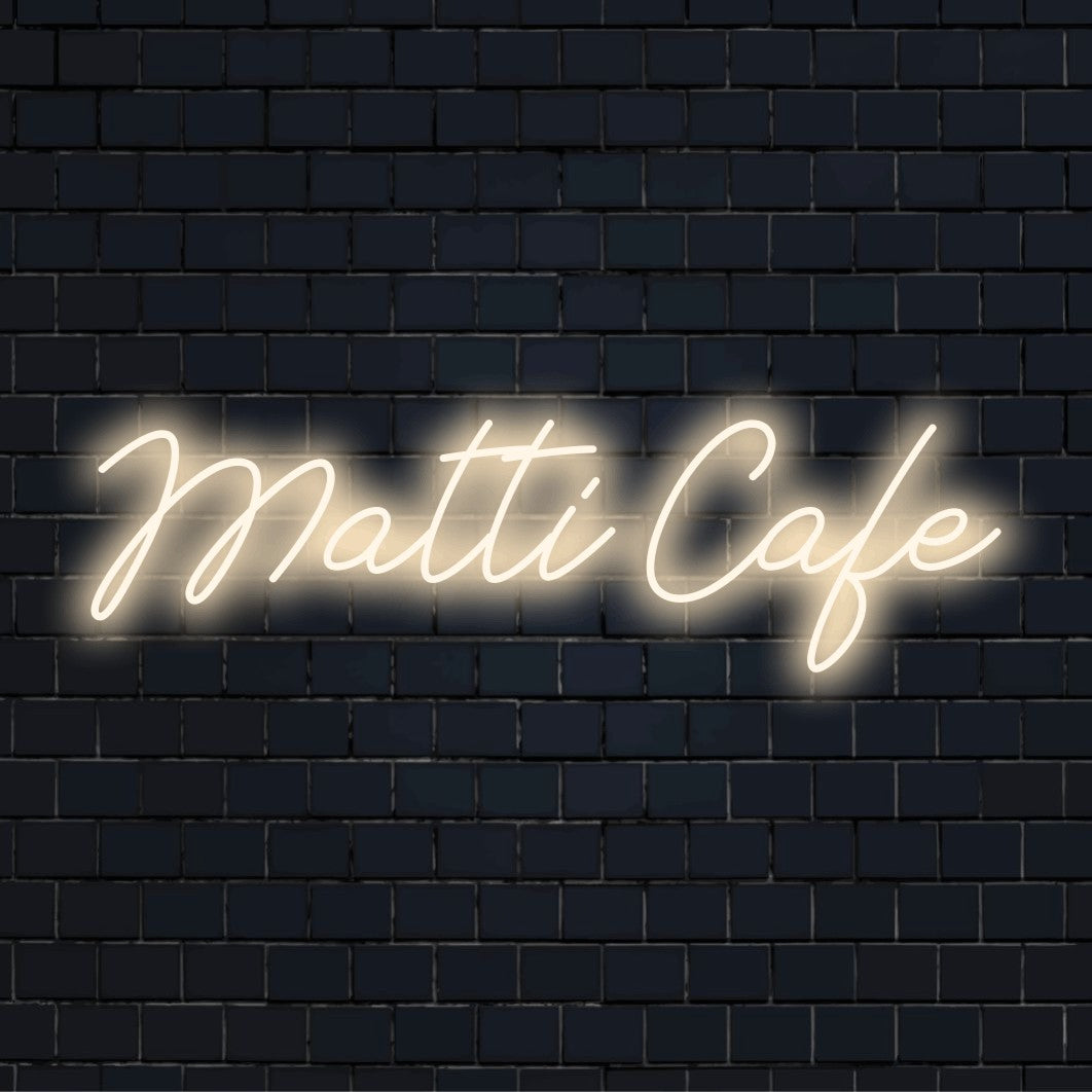 Matti Cafe Custom Name Neon Sign, neon text light against black brick wall