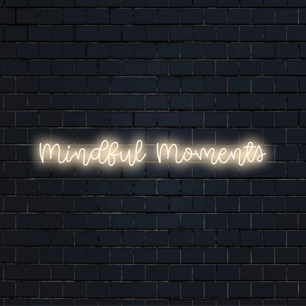 Mindful Moments LED Neon Sign, glowing wall decor against black brick wall