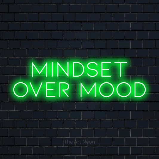 "Mindset Over Mood" script-style LED neon sign on a black brick wall