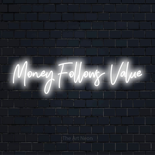 "Money Follows Value" text design with neon effect on a black brick wall