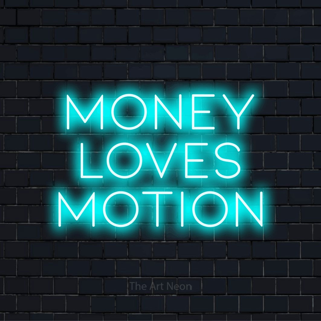 "Money Loves Motion" script-style LED neon sign on a black brick wall