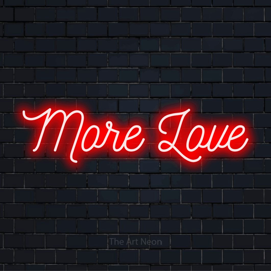 "More Love" LED neon sign on a black brick wall