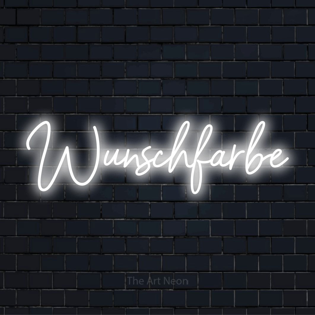 LED-Neonschild mit dem Text „Wunschfarbe“ auf dunkler Ziegelwand