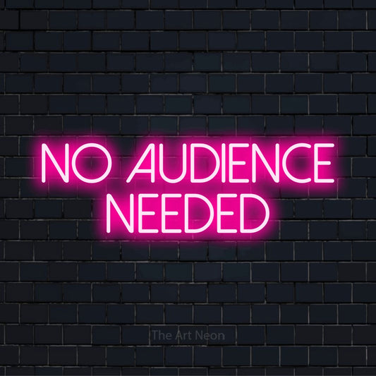 "No Audience Needed" script-style LED neon sign on a black brick wall