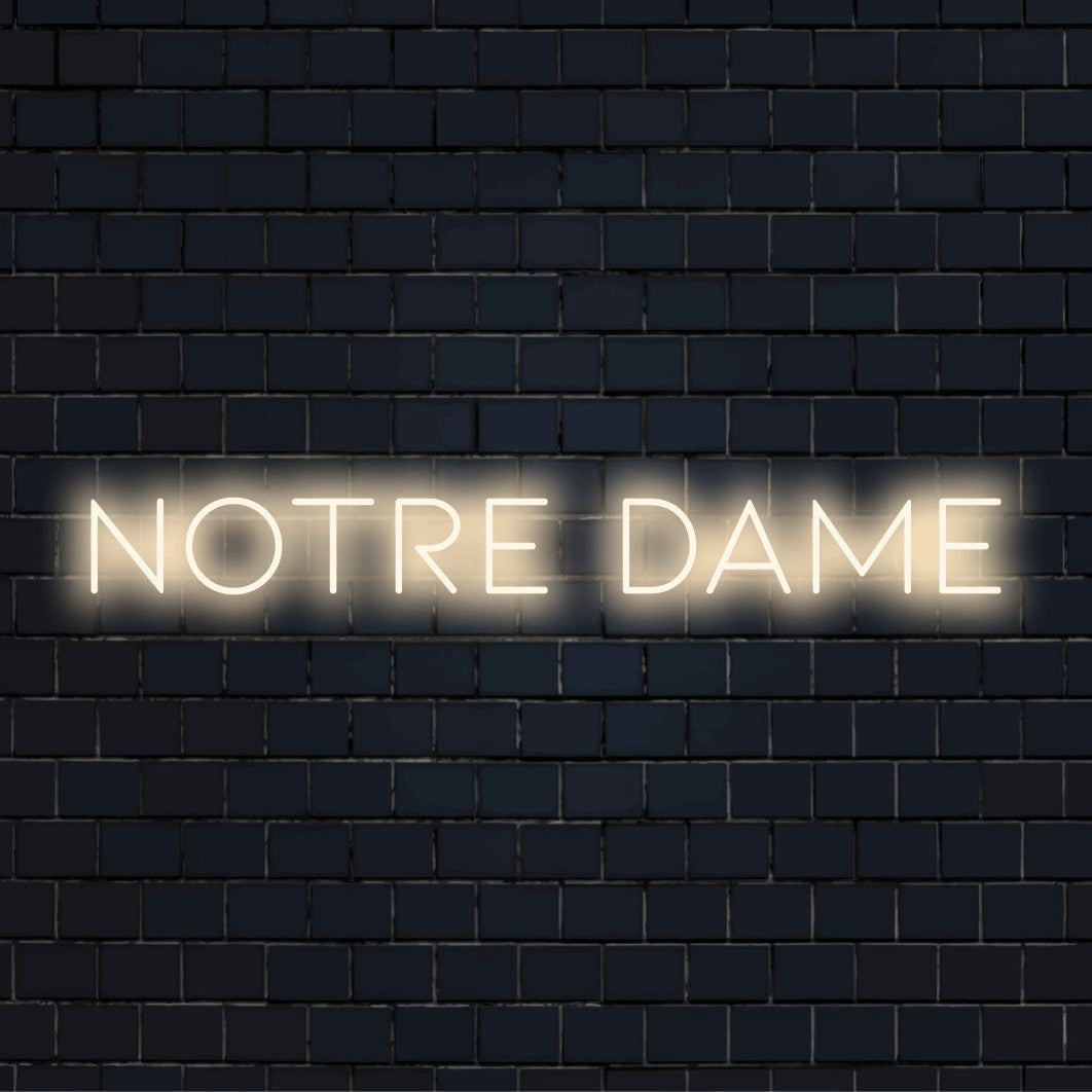 Notre Dame LED Neon Sign, glowing wall decor against black brick wall
