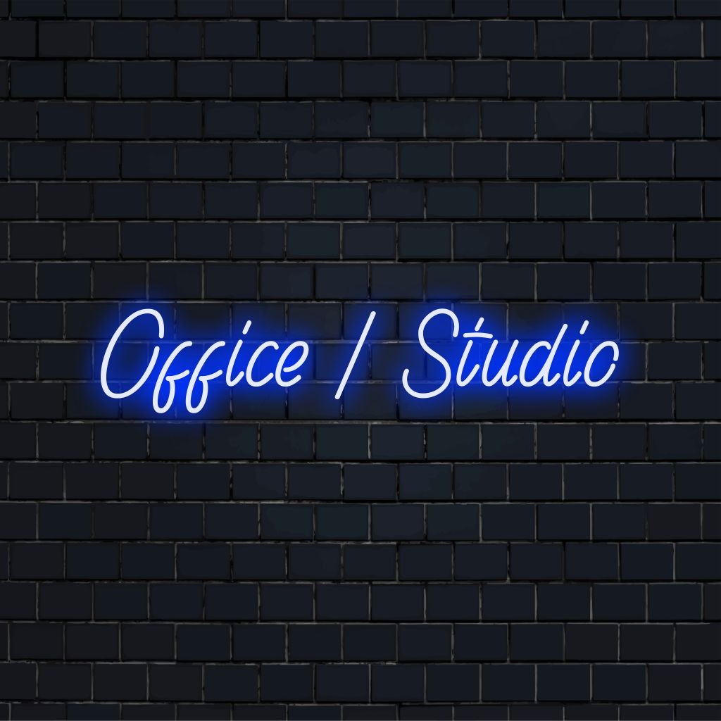 Office Studio Neon Light with glowing wall decor against brick backdrop